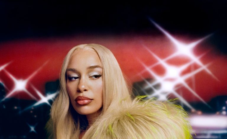 English singer Jorja Smith featuring blonde hair and a fur collar in a stylised press photo captured by Bolade Banjo.